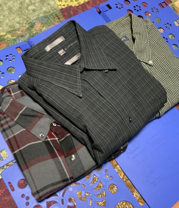 Folded plaid and checkered shirts showcasing ultra-specific products for stylish wardrobe essentials.