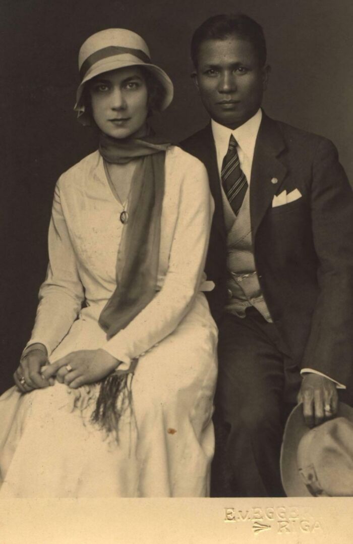 A couple from 50-100 years ago, woman in a hat and scarf, man in a suit and tie, illustrating rare historical change.