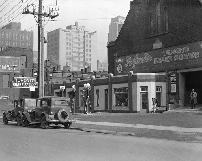 Historic scene of vintage cars at a Toronto brake service shop, showcasing world change over decades.