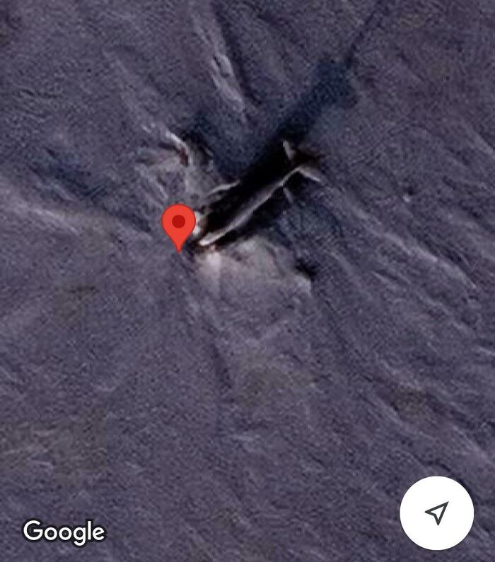 Strange object found on Google Earth, marked with a red location pin on a rugged surface.