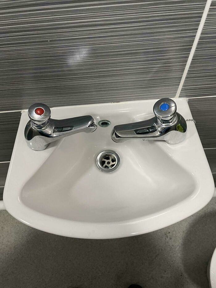 Design fail with reversed hot and cold taps on a small sink.