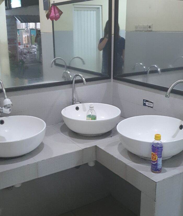 Three sinks with misplaced faucets, creating a design fail.