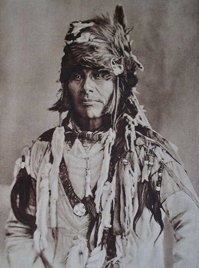 Portrait of a man in traditional attire with headpiece, from 50-100 years ago, illustrating how the world has changed.