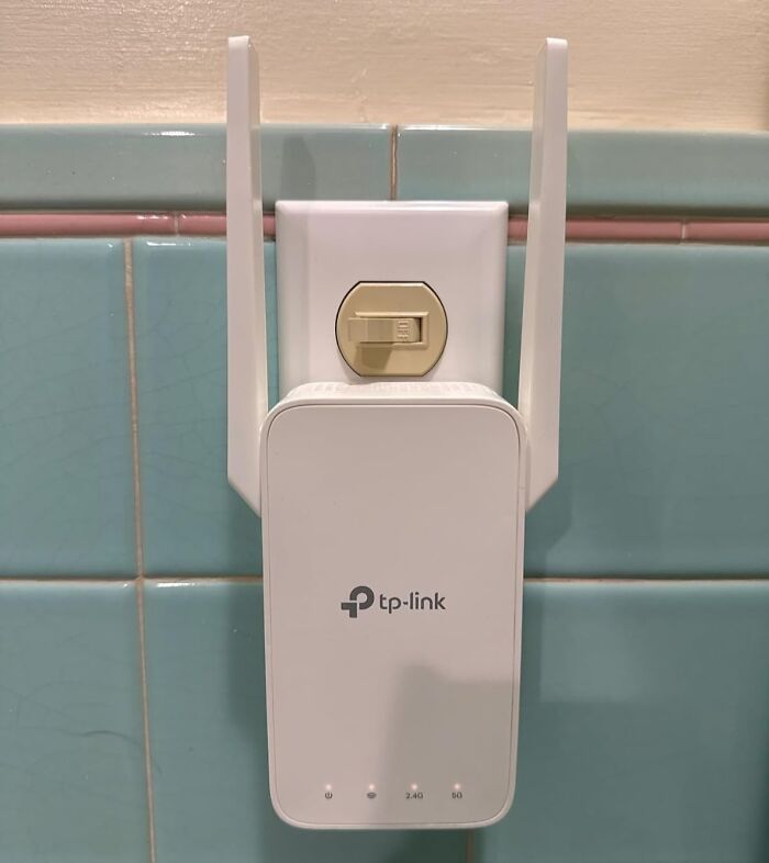 TP-Link WiFi extender plugged into a wall socket, featured in Amazon Spring Deals.