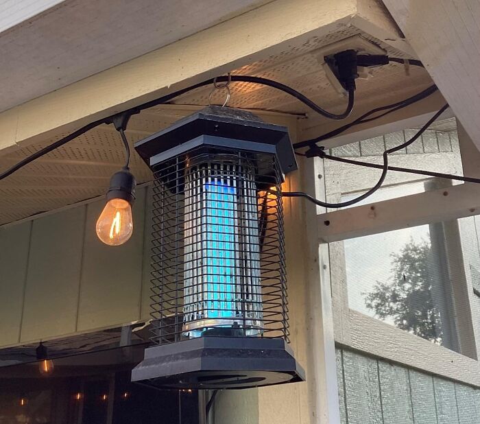 Hanging bug zapper on a porch with a bulb nearby, showcasing Amazon spring deals.