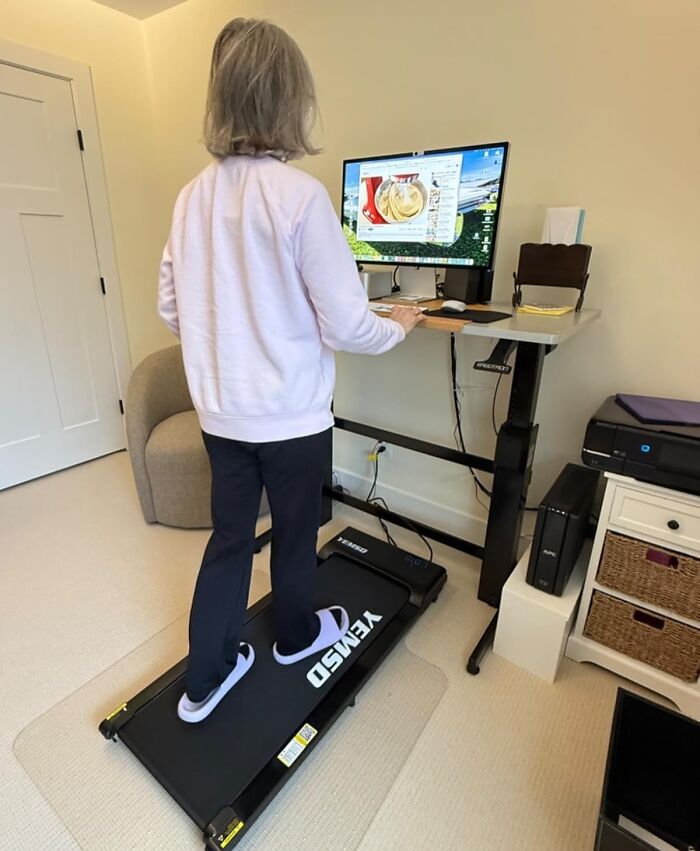 Person using a treadmill desk in a home office, highlighting Amazon spring deals for fitness and productivity.