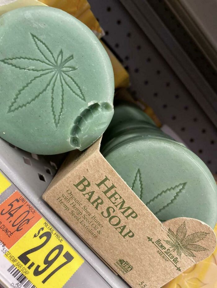 Green hemp bar soap with leaf design in cardboard packaging on store shelf, priced at $2.97.