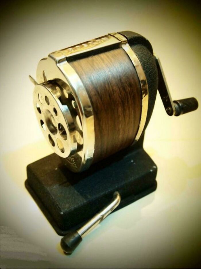 Vintage mechanical pencil sharpener with wooden details and metal crank, nostalgic pics from people realizing they're old now.
