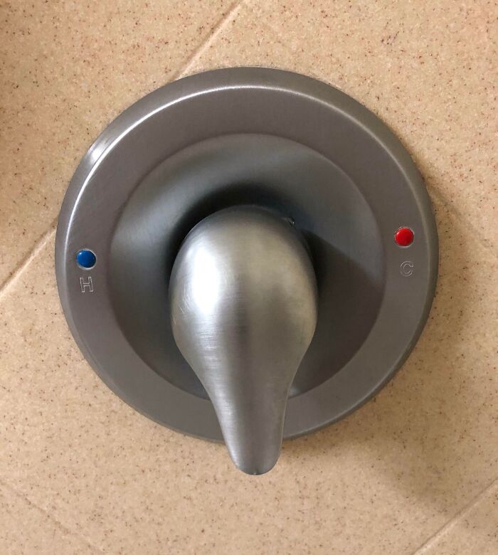 Shower handle design fail with hot and cold indicators switched.