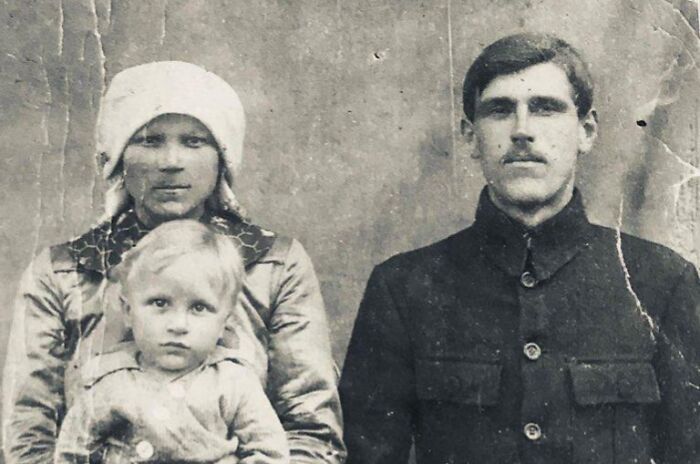 Vintage family portrait showing world change over the decades, featuring a man, woman, and child in period clothing.