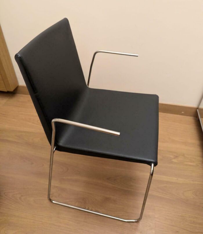 Chair with misaligned armrests demonstrating a design fail.