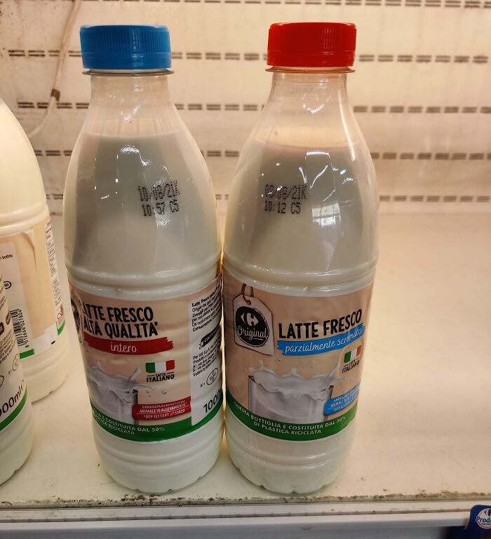 Design fails: Mixed printed dates on Italian milk bottles with blue and red caps in a refrigerator aisle.