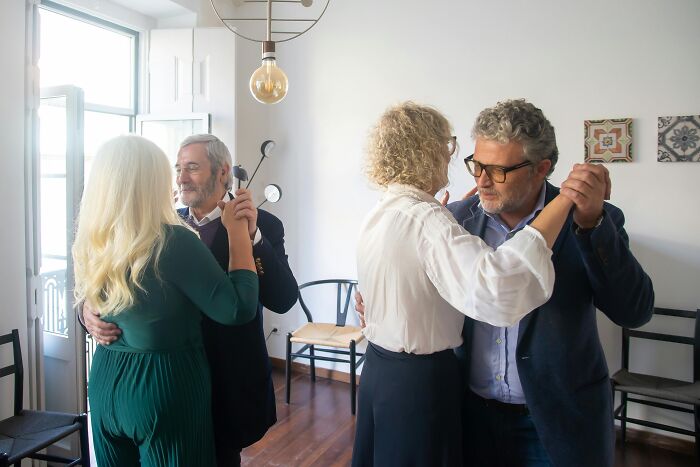 Elderly couples dancing in a cozy room, illustrating simple approaches to enhancing life quality.