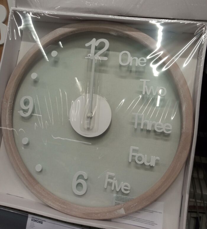 Clock design fail with numbers replaced by words, showing "One" through "Five" incorrectly placed.