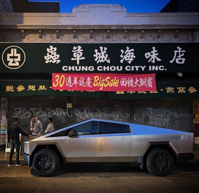Futuristic vehicle in Chinatown, captured by photographer's lens, embodies San Francisco essence.