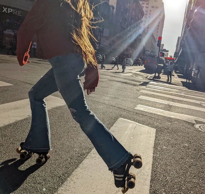 Roller skater crossing a sunlit street in San Francisco, captured by photographer Sage Akaboshi.