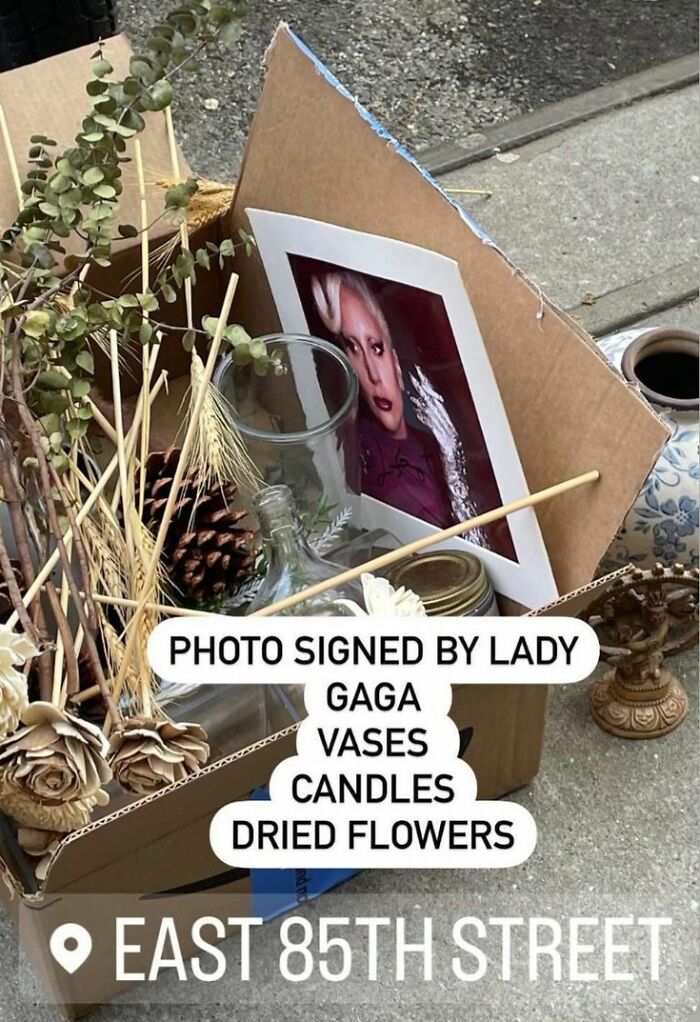 NYC curbside find with vases, candles, dried flowers, and signed photo at East 85th Street.