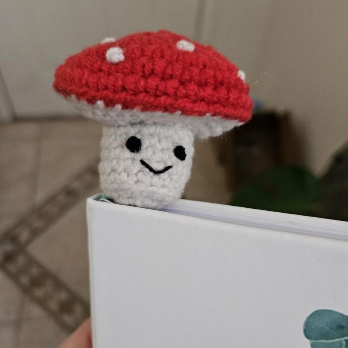 Crocheted mushroom bookmark on book corner, example of random Amazon finds sparking joy.
