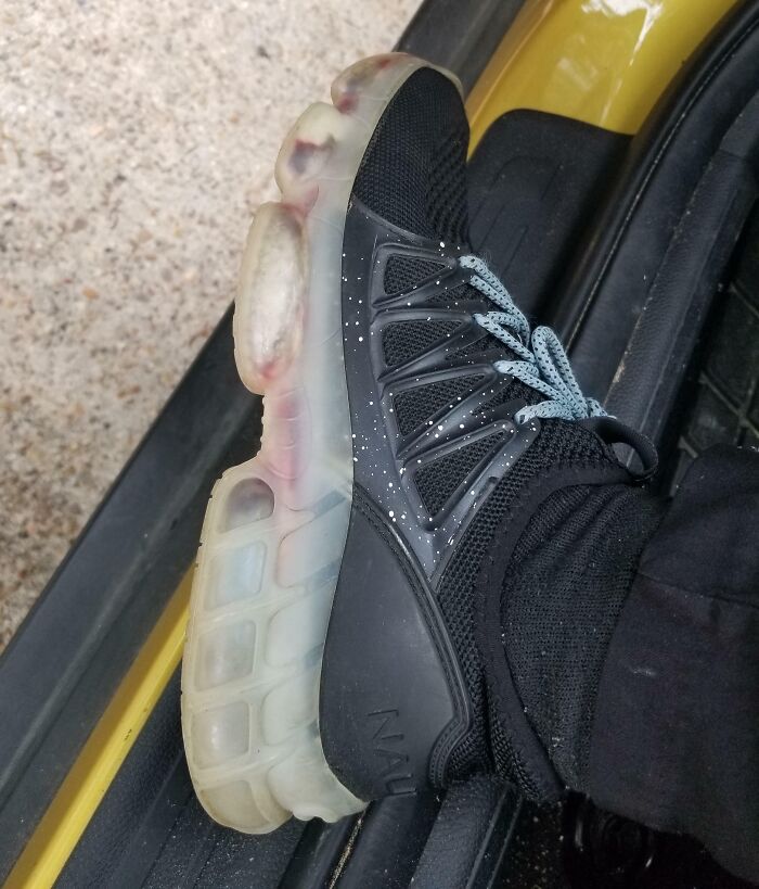 Black sneaker with transparent sole showing a design fail.