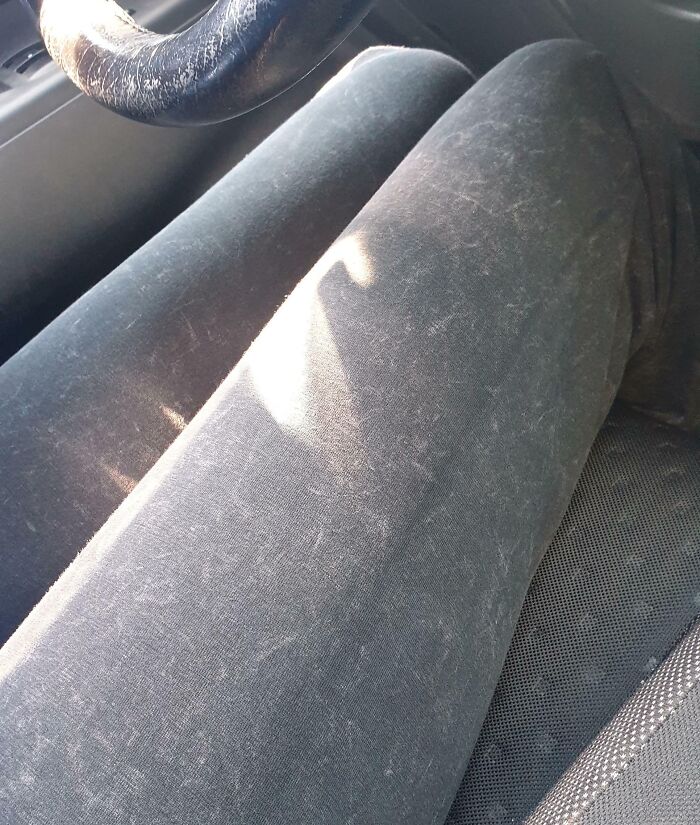 Black pants covered in pet hair, highlighting design fails in lint resistance.