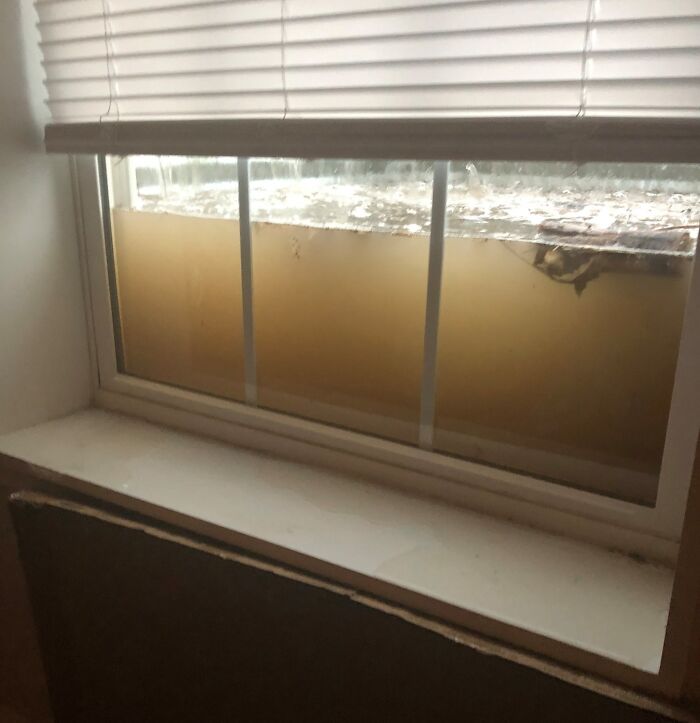Flooded basement window showing potential expensive accident damage.