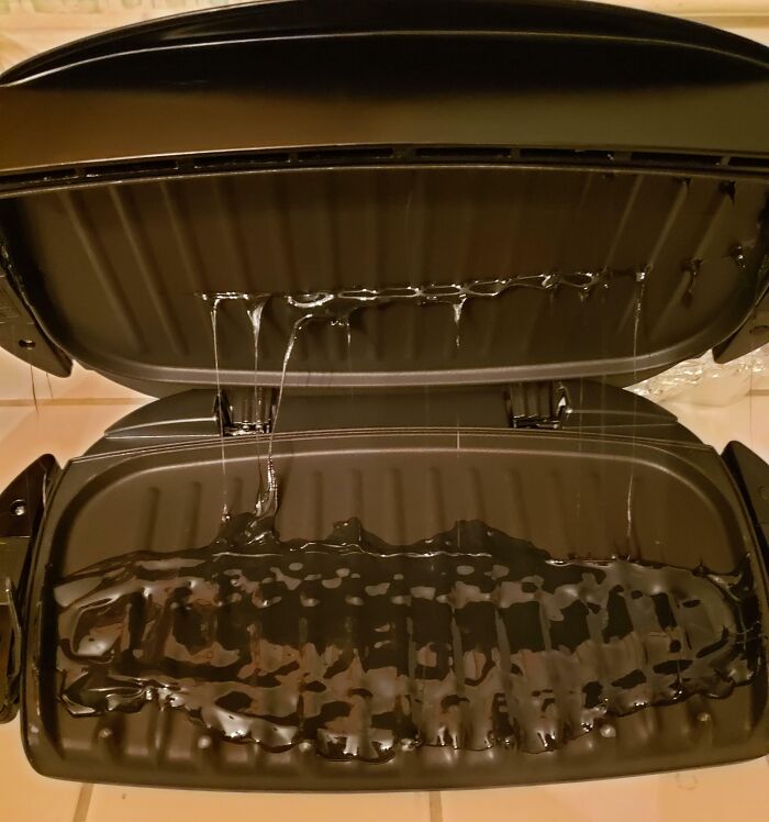 Grill with melted plastic on surface after an expensive accident.