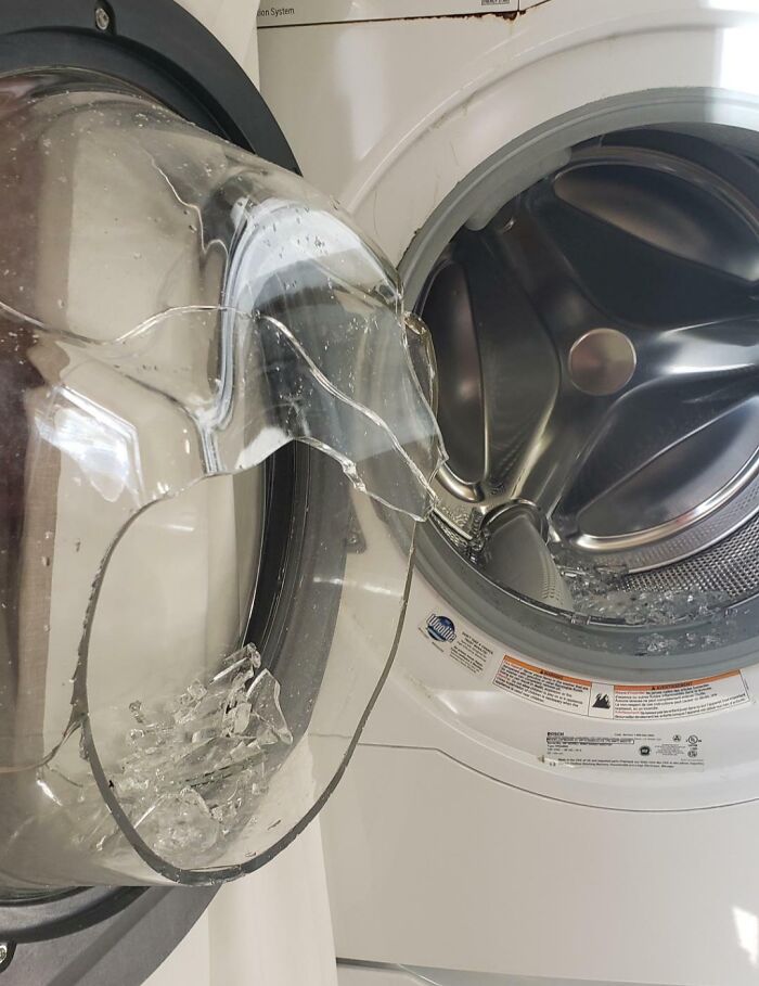 Washer with shattered door, highlighting expensive accident aftermath.