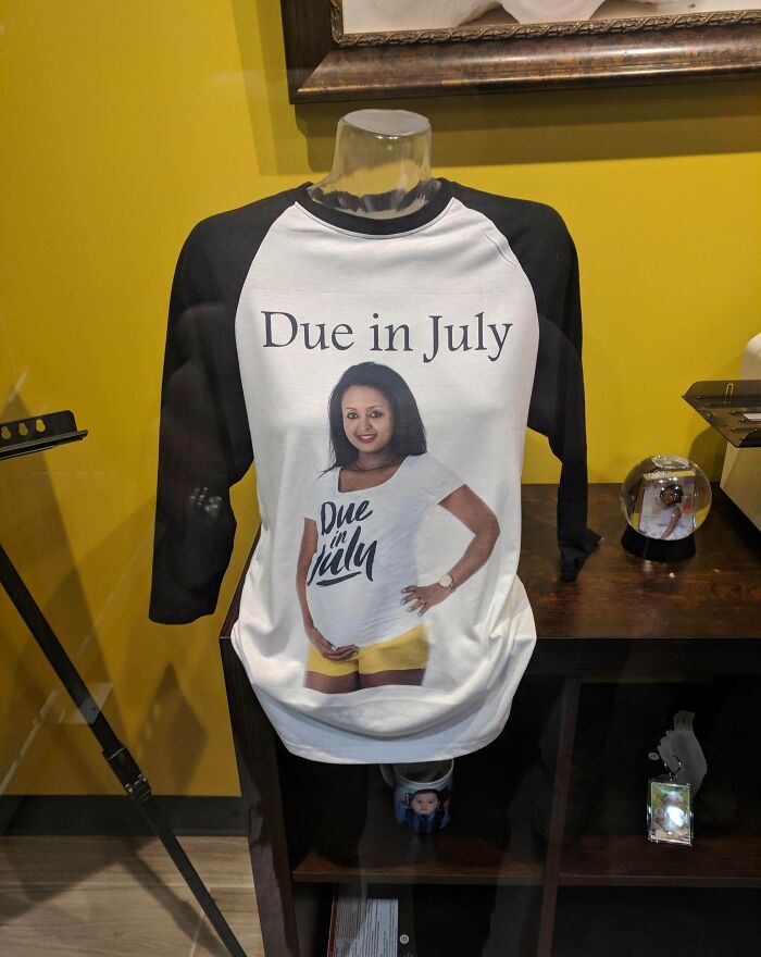 T-shirt design fail features mannequin wearing shirt with "Due in July" graphic and photo of same shirt worn.