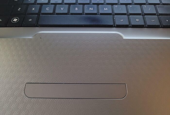 Laptop keyboard design fail with an off-centered trackpad, highlighting a common design fail.