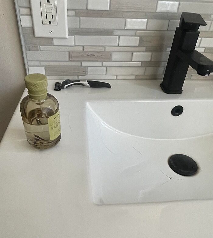 C*****d sink with expensive shaving kit nearby, illustrating costly accidents.