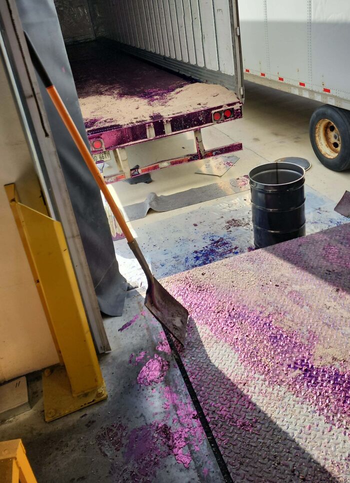 "Spilled purple substance in truck unloading area highlights costly accident aftermath."