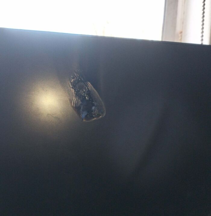 Damaged TV screen with a burn mark from a super expensive accident.