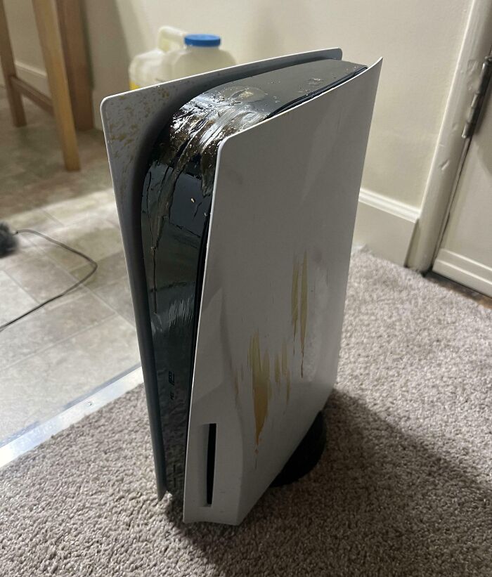 Damaged gaming console with melted casing, indicating a costly accident.