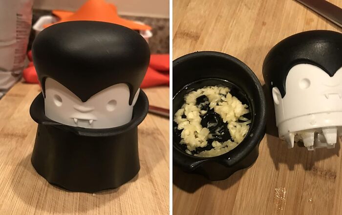 Vampire-themed garlic crusher on a wooden counter, showcasing a creative kitchen game-changer.