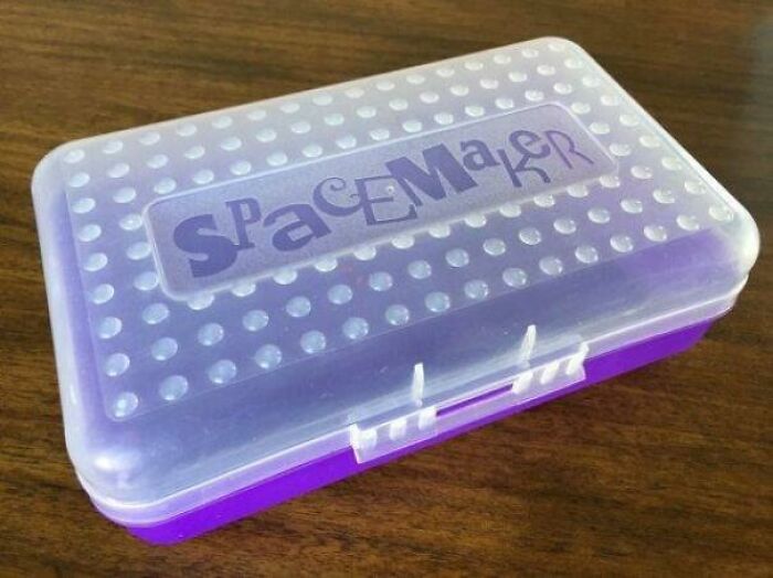 Purple Spacemaker pencil box, a classic item that encapsulates the 1980s vibe, sitting on a wooden surface.