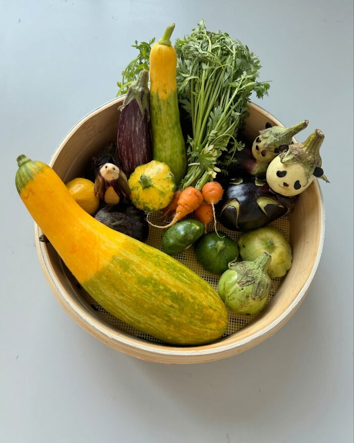 Adorable food art featuring a variety of creatively arranged vegetables in a bamboo tray.