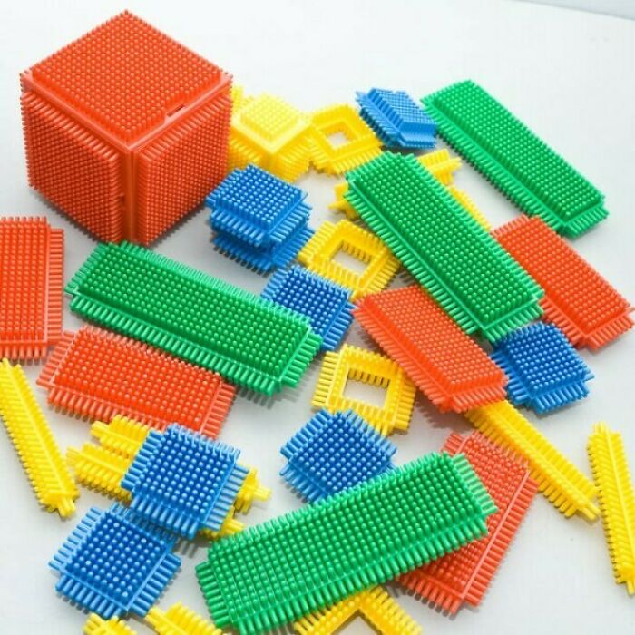 Colorful 1980s toy building blocks scattered on a surface.
