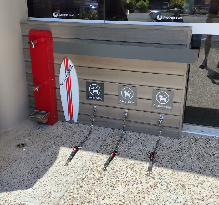 Puppy parking area with water station outside an Australian post office, showcasing citizen-friendly amenities.
