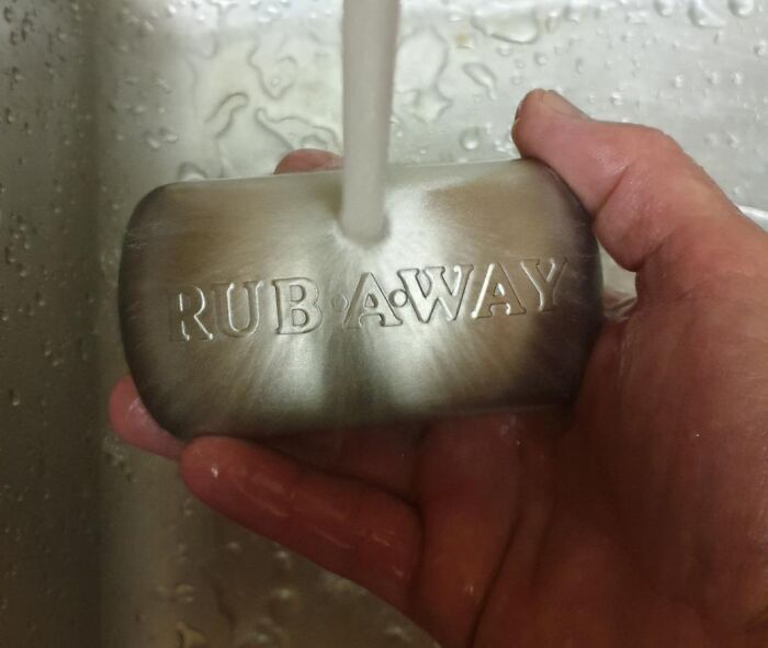 Stainless steel soap under running water, labeled 'Rub Away' for better quality of life in the kitchen.