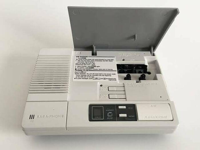 1980s answering machine with an open tape compartment showcasing retro technology.
