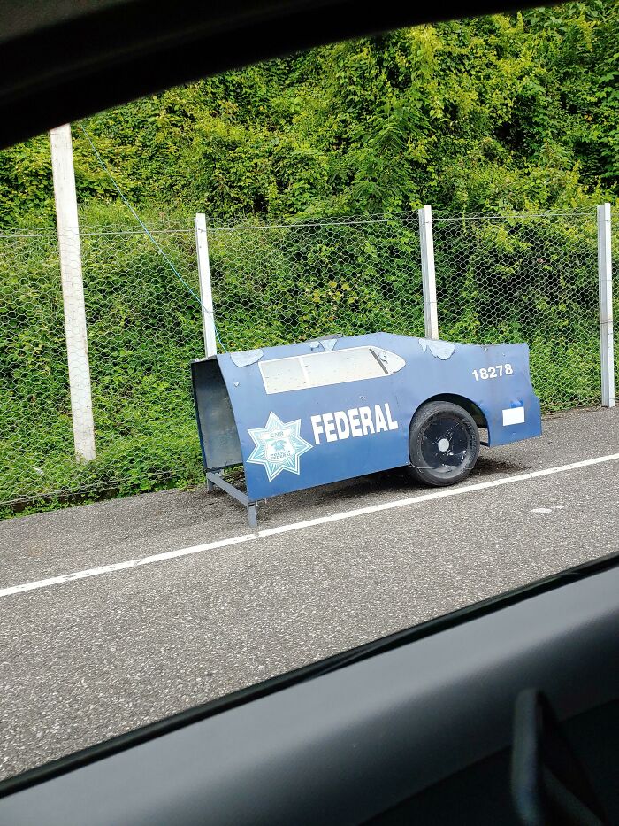 A decoy police car on roadside, illustrating how countries creatively ensure citizen safety.