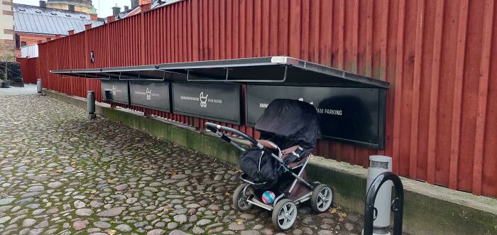 Stroller parked under a shelter in a European country, showcasing unique citizen care with stroller parking.