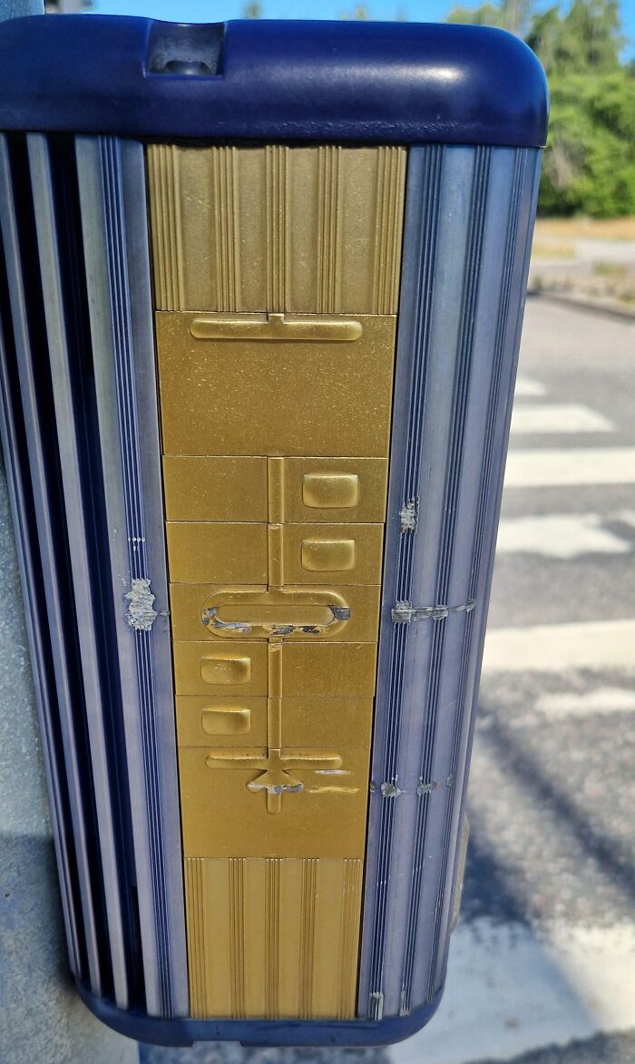 Braille panel on a pedestrian crossing button, showcasing how countries care for visually impaired citizens.