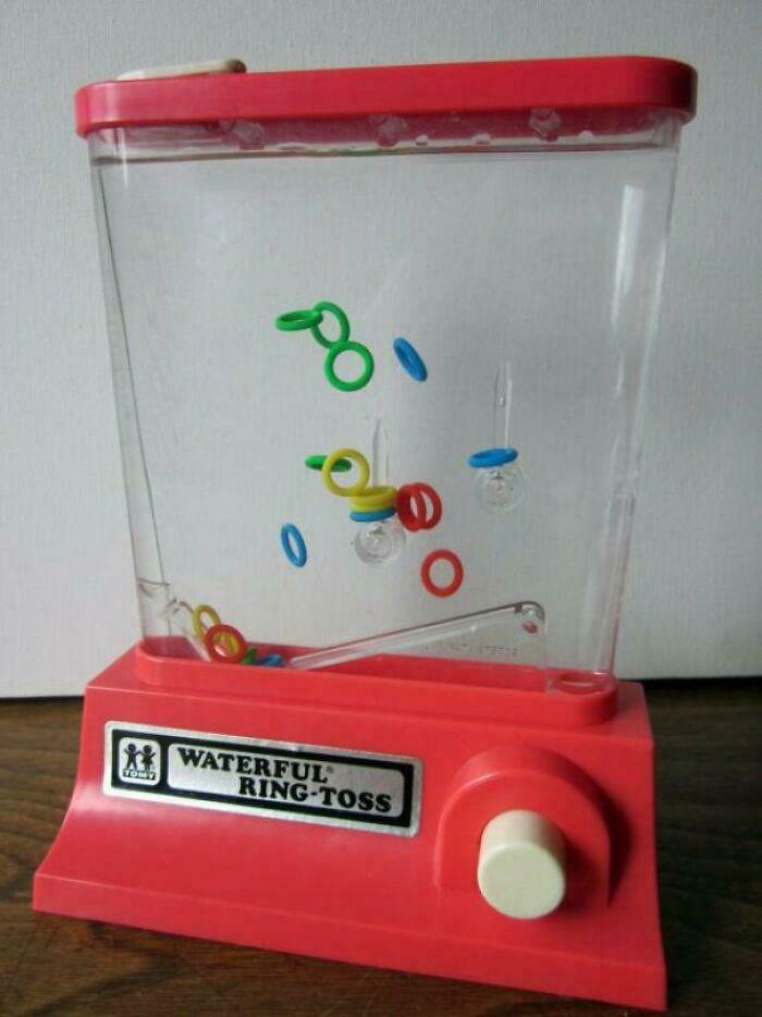 Vintage 1980s Waterful Ring-Toss game with red base and colorful rings floating inside a clear container.