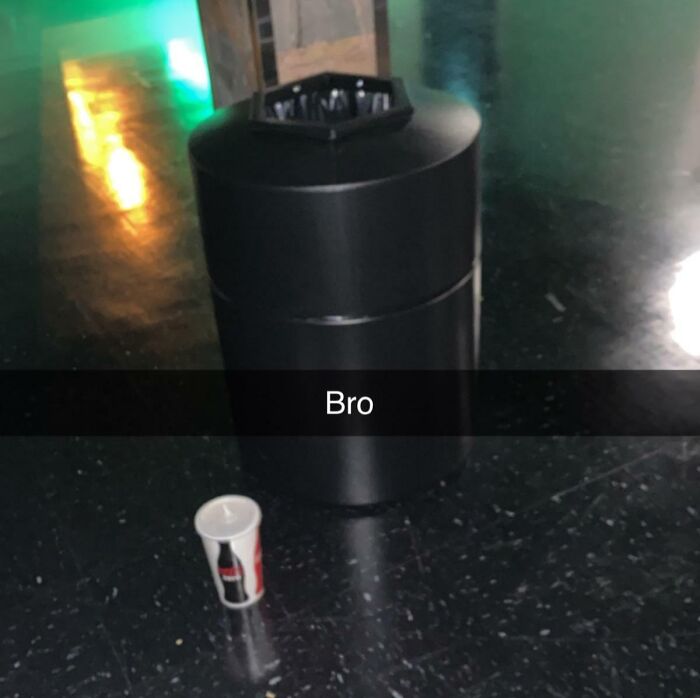 Trash can with a cup next to it on the floor, illustrating customer cluelessness humor.