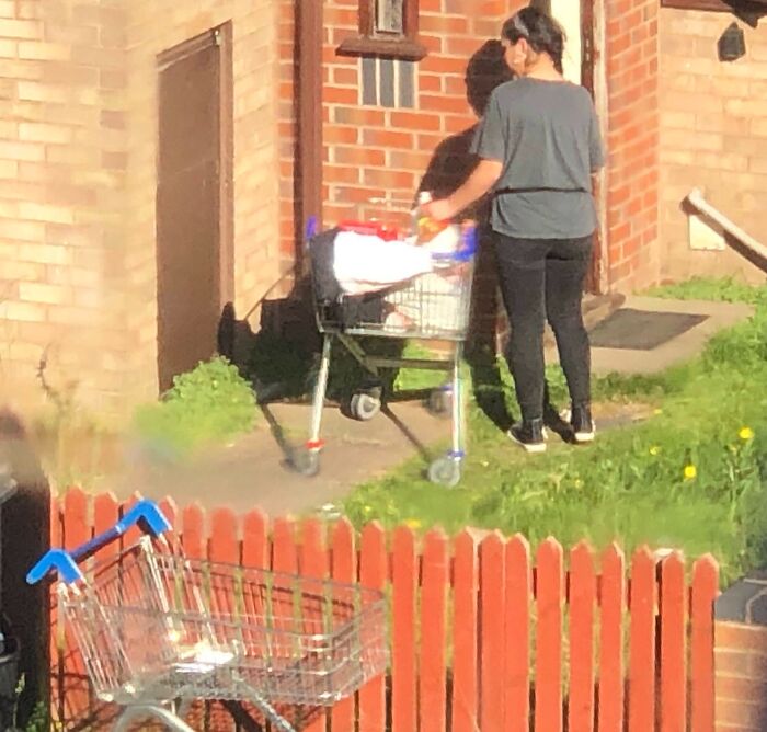 Person bringing a shopping cart up to a house, highlighting customer cluelessness.