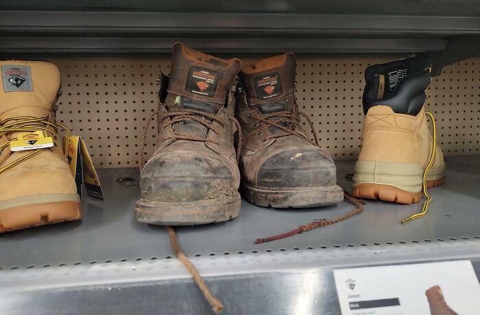 Worn, muddy boots on a store shelf showcasing extreme customer cluelessness.