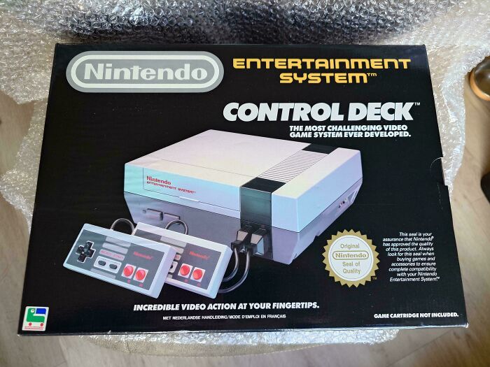 Nintendo Entertainment System box, featuring the iconic 1980s Control Deck and controllers in original packaging.