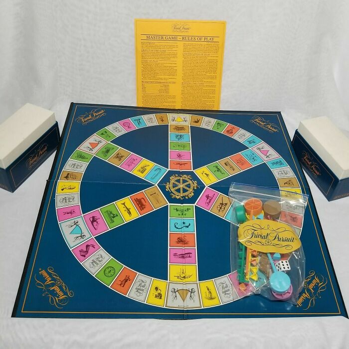 1980s Trivial Pursuit board game set with colorful pieces and rule sheet.