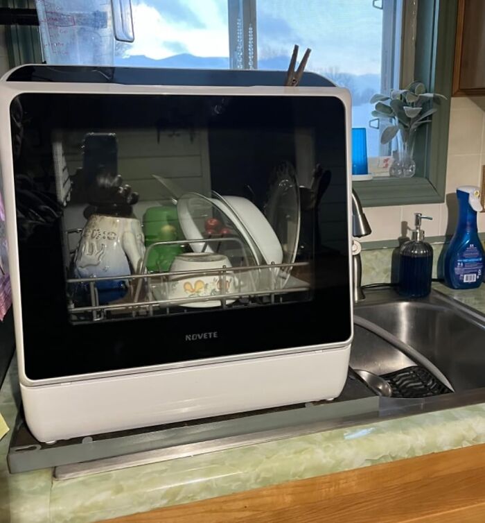 Compact dishwasher on kitchen counter, enhancing the quality of life by making dishwashing less hard.